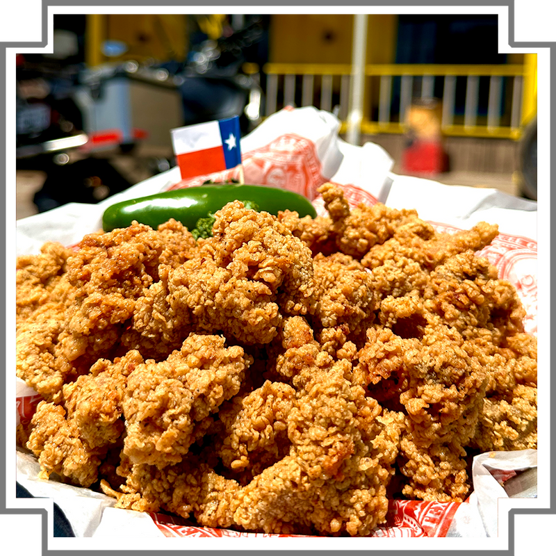 Basket of fried mountain oysters with a Texas flag in the background