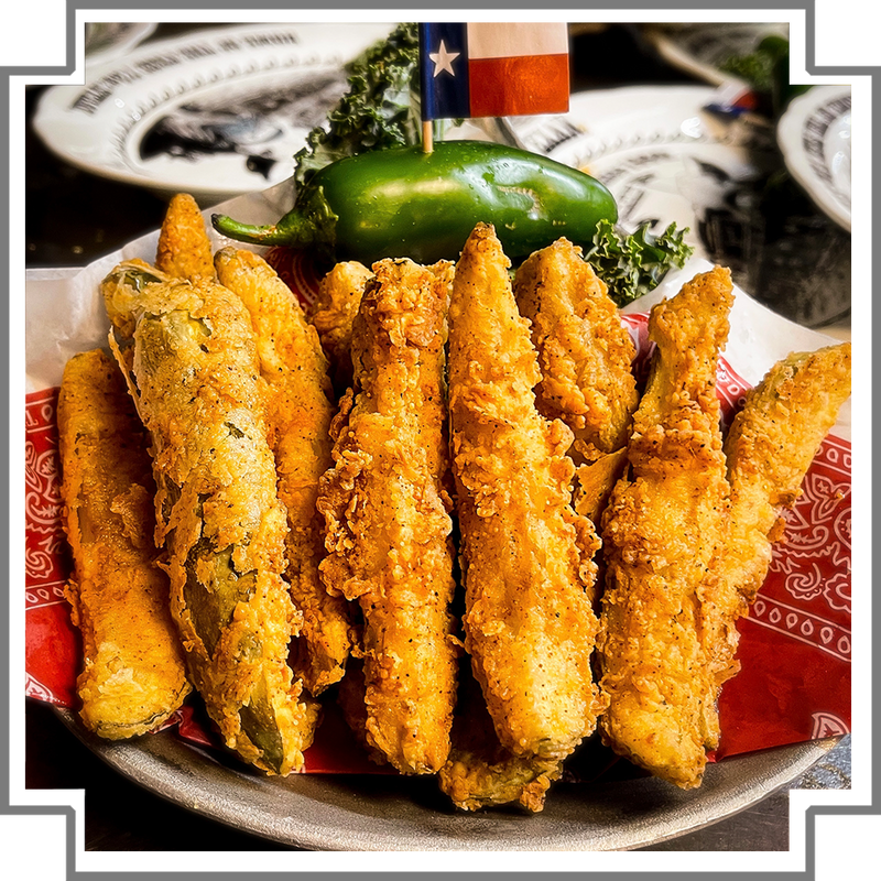 Fried pickles on a plate with a Texas flag in the background