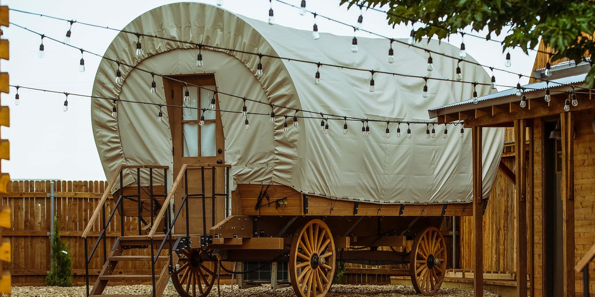 Traditional covered wagon with wooden wheels in a rustic setting