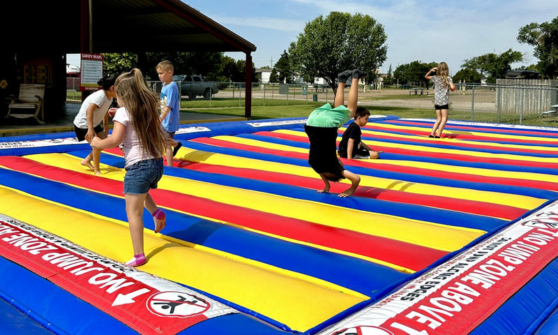 Children playing on a colorful inflatable trampoline