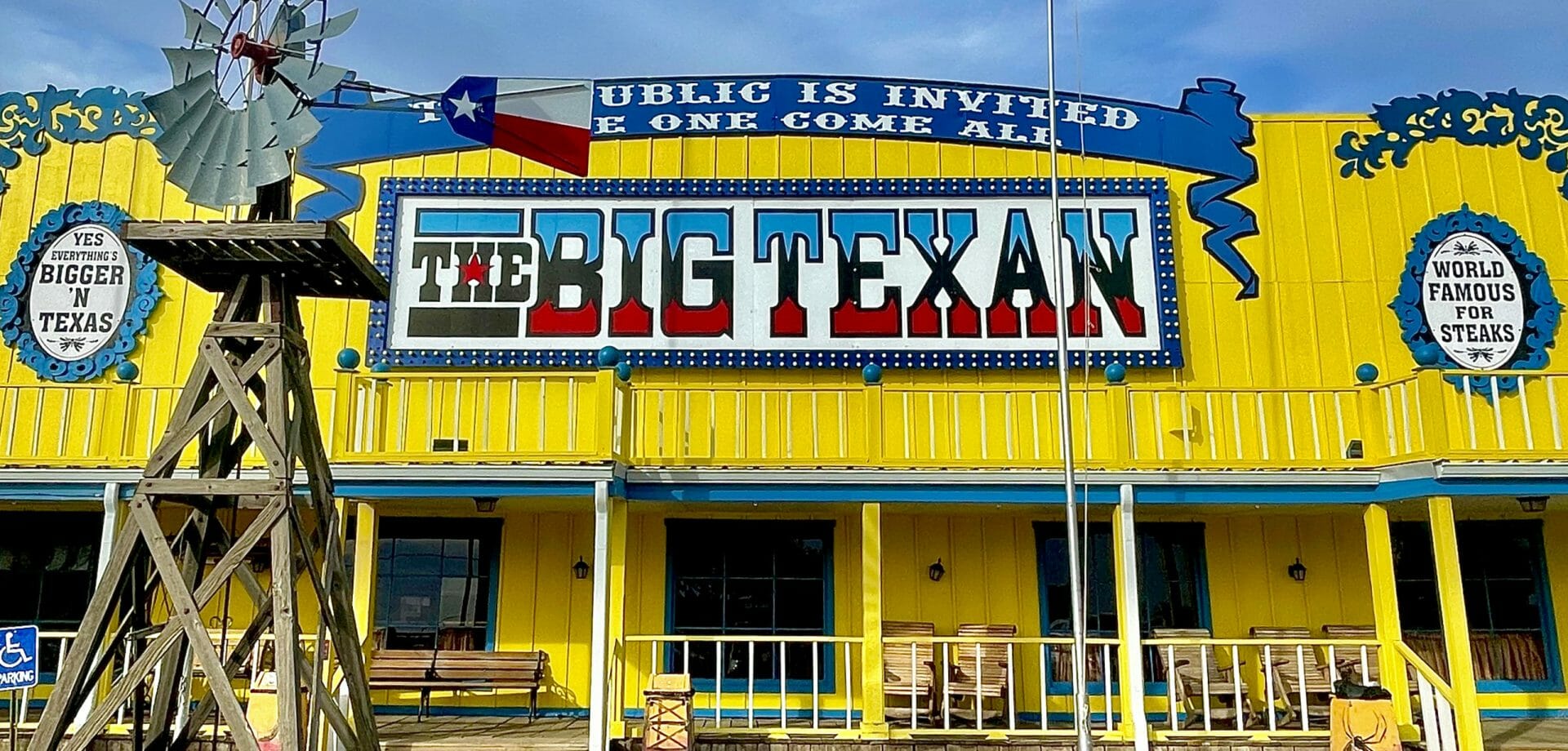 The Big Texan restaurant with a windmill and blue sky background