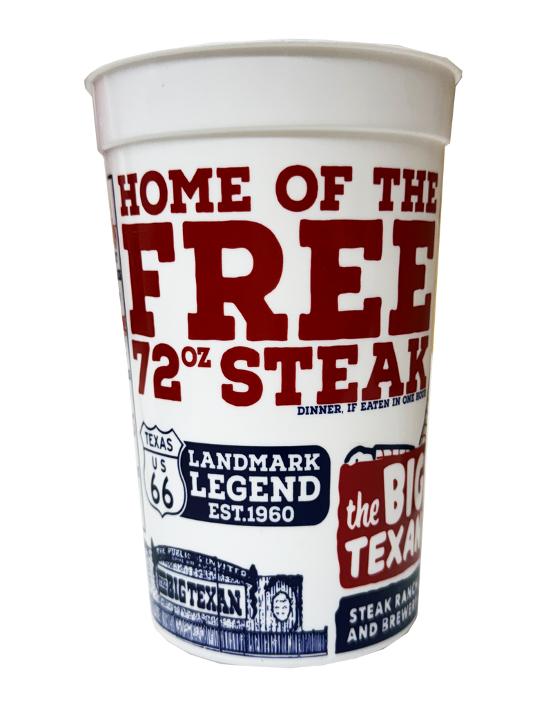 White plastic cup with red and blue text and graphics featuring ' home of the free 72oz steak' on a white background
