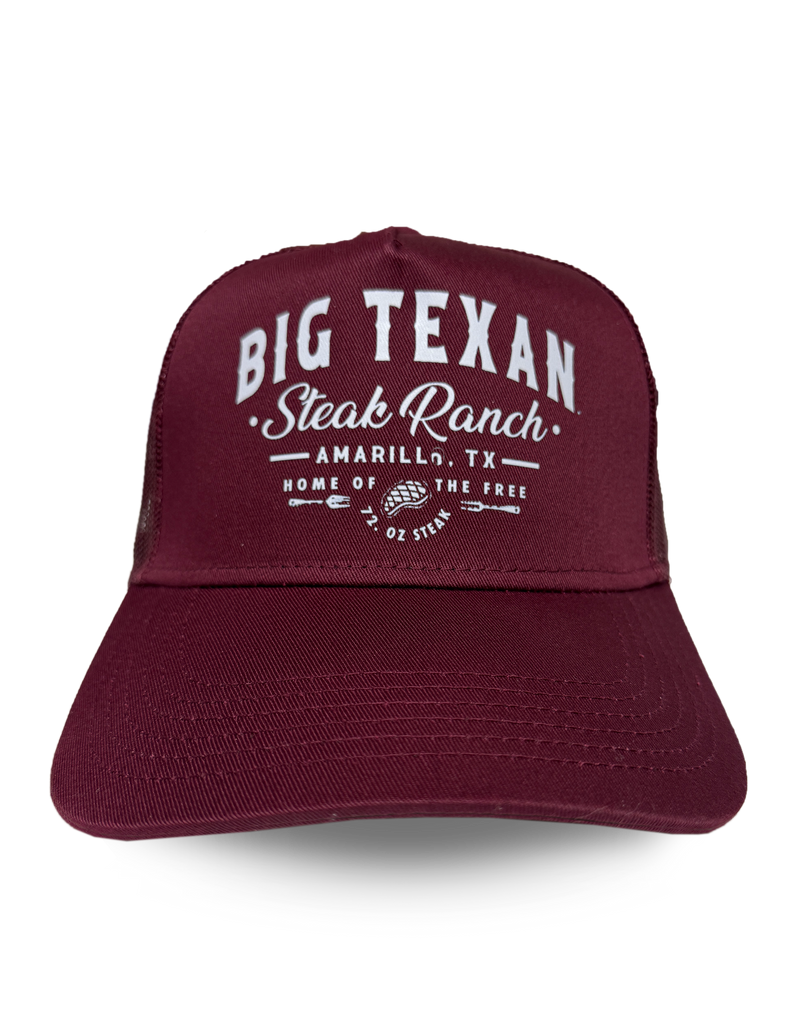 Front view of maroon trucker cap with 'Big Texan Steak Ranch Amarillo TX Home of the free 72oz steak' text in white lettering
