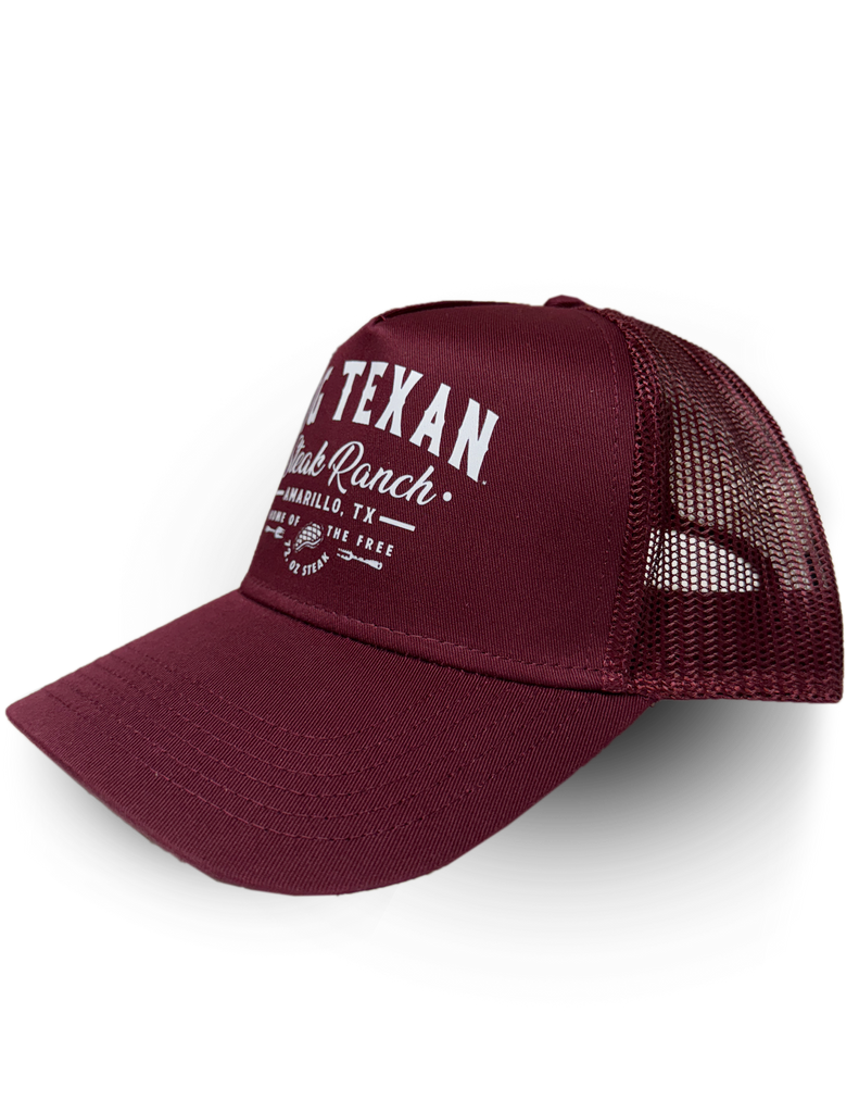 Side view of maroon trucker cap with 'Big Texan Steak Ranch Amarillo TX Home of the free 72oz steak' text in white lettering 