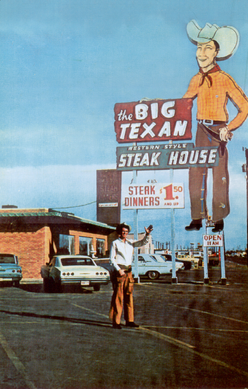 Vintage photo The Big Texan Steak Ranch with a cowboy waving and classic cars.